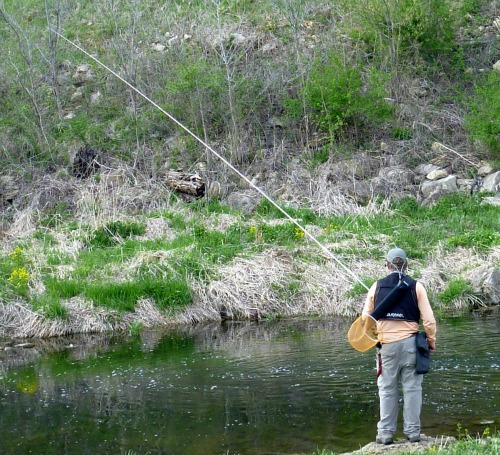 Angler holding a 24' fishing rod.