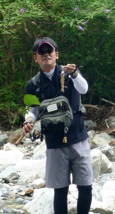 Takuya Shiozawa holding small iwana.